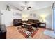 Comfortable living room featuring matching sofas, ceiling fan and neutral walls at 734 Olympic Cir # 30, Ocoee, FL 34761