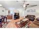 Open-concept living area flows seamlessly into kitchen, with cozy seating and ceiling fan at 734 Olympic Cir # 30, Ocoee, FL 34761
