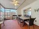 The screened patio has a ceiling fan, dining table, grill, and access to the backyard at 734 Olympic Cir # 30, Ocoee, FL 34761