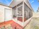 Exterior view of the screened in patio with access to backyard and outdoor storage at 734 Olympic Cir # 30, Ocoee, FL 34761