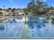 Aerial view of a pair of tennis courts showcasing well-maintained recreational amenities at 734 Olympic Cir # 30, Ocoee, FL 34761