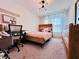 Bedroom featuring a wooden bed frame, stylish lighting, and comfortable carpet at 8628 Dufferin Ln, Orlando, FL 32832