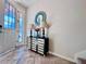 Welcoming entryway with a decorative cabinet and glass door allowing plenty of natural light at 8628 Dufferin Ln, Orlando, FL 32832