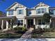 Charming two-story home with blue shutters, front porch, and manicured landscaping at 8628 Dufferin Ln, Orlando, FL 32832