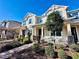 Charming two-story home with blue shutters, front porch, and mature landscaping at 8628 Dufferin Ln, Orlando, FL 32832