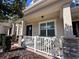 Welcoming front porch features stone accents, seating area, and view of the front yard at 8628 Dufferin Ln, Orlando, FL 32832