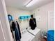 Functional laundry room equipped with a washer, dryer, and shelving for storage at 8628 Dufferin Ln, Orlando, FL 32832
