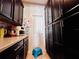 Walk-in pantry features ample cabinet space, quartz countertops, and tiled backsplash at 8628 Dufferin Ln, Orlando, FL 32832
