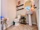 Stylish powder room featuring unique fixtures, shelves, and tile flooring at 8628 Dufferin Ln, Orlando, FL 32832