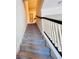 Carpeted staircase with dark wood handrail and white balusters leads to the upper level at 8628 Dufferin Ln, Orlando, FL 32832