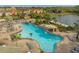 Aerial view of resort-style pool, with a waterslide, lounging area, and beautiful landscaping in a vibrant community at 8971 Majesty Palm Rd, Kissimmee, FL 34747
