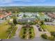An aerial view of a community clubhouse with pool, tennis court, and pond at 8971 Majesty Palm Rd, Kissimmee, FL 34747