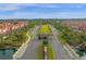Aerial view of a gated community entrance with lush landscaping, and serene ponds at 8971 Majesty Palm Rd, Kissimmee, FL 34747
