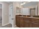 This bathroom has a double sink vanity with granite countertop and a shower at 8971 Majesty Palm Rd, Kissimmee, FL 34747