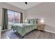 Bright bedroom featuring a large window and comfortable queen bed at 8971 Majesty Palm Rd, Kissimmee, FL 34747