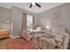 This bedroom includes twin beds, curtains, and a chair at 8971 Majesty Palm Rd, Kissimmee, FL 34747