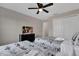 This cozy bedroom has twin beds, ceiling fan, TV, and closet space at 8971 Majesty Palm Rd, Kissimmee, FL 34747