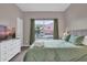 Bright bedroom featuring a large window and comfortable queen bed at 8971 Majesty Palm Rd, Kissimmee, FL 34747