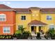 Colorful townhome featuring a red tile roof and inviting front entrance at 8971 Majesty Palm Rd, Kissimmee, FL 34747