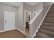 Home foyer with access to the bathroom and wooden staircase at 8971 Majesty Palm Rd, Kissimmee, FL 34747