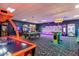 Fun-filled game room featuring arcade games, a pool table, and colorful lighting, perfect for entertainment and leisure at 8971 Majesty Palm Rd, Kissimmee, FL 34747
