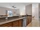 Open concept kitchen with stainless steel appliances, island, and eat-in dining area at 8971 Majesty Palm Rd, Kissimmee, FL 34747
