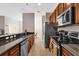 Long galley kitchen featuring stainless steel appliances and granite countertops at 8971 Majesty Palm Rd, Kissimmee, FL 34747