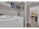 This laundry room has a washer, dryer, and storage space at 8971 Majesty Palm Rd, Kissimmee, FL 34747