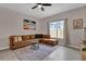 Cozy living room with neutral paint, ceiling fan and plush sectional sofa at 8971 Majesty Palm Rd, Kissimmee, FL 34747