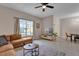 Bright living room featuring neutral paint, ceiling fan and view of the backyard at 8971 Majesty Palm Rd, Kissimmee, FL 34747