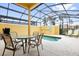 Relax by your private screened-in pool with table and chairs at 8971 Majesty Palm Rd, Kissimmee, FL 34747