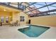 Enjoy this screened-in pool with table and chairs at 8971 Majesty Palm Rd, Kissimmee, FL 34747