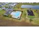 Aerial view of a community pool, playground, and well-maintained grounds at 9012 Tuscan Cypress St, Kissimmee, FL 34747