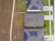 Overhead view of neighborhood houses with solar panels and well-maintained lawns in a residential community at 9012 Tuscan Cypress St, Kissimmee, FL 34747