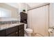 Bathroom featuring granite countertops, a shower with curtain and a cabinet at 9012 Tuscan Cypress St, Kissimmee, FL 34747