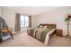 Bright bedroom with a large bed, desk, and neutral tones at 9012 Tuscan Cypress St, Kissimmee, FL 34747
