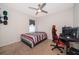 Bedroom with a ceiling fan, a window, and an accent wall at 9012 Tuscan Cypress St, Kissimmee, FL 34747
