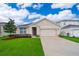 Charming single-Gathering home featuring a well-manicured lawn and attached two-car garage at 9012 Tuscan Cypress St, Kissimmee, FL 34747