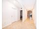 Bright hallway featuring neutral paint, tile flooring, and arched doorways that lead into various rooms of the home at 9012 Tuscan Cypress St, Kissimmee, FL 34747