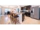 Modern kitchen featuring a center island with bar stool seating, stainless steel appliances, and granite countertops at 9012 Tuscan Cypress St, Kissimmee, FL 34747