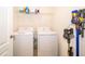 Laundry room with washer, dryer, shelving, and convenient storage at 9012 Tuscan Cypress St, Kissimmee, FL 34747