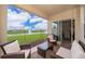 Covered patio with outdoor furniture overlooking a serene pond with a fountain at 9012 Tuscan Cypress St, Kissimmee, FL 34747