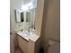 Bathroom featuring a mirror, a sink, and a toilet at 996 Dolphin Dr, Winter Garden, FL 34787