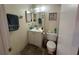 Bathroom with a sink, toilet, and decorative wall art at 996 Dolphin Dr, Winter Garden, FL 34787