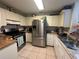 Bright kitchen with a stainless steel refrigerator and tile flooring at 996 Dolphin Dr, Winter Garden, FL 34787