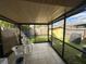 The enclosed patio offers an outside seating area and views of the backyard, including the storage shed at 996 Dolphin Dr, Winter Garden, FL 34787