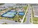 Aerial view of the tennis and basketball courts and a neighborhood lake at 10414 Folly Beach Rd, Orlando, FL 32827