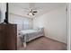Cozy bedroom features carpet, a ceiling fan, and natural light at 10414 Folly Beach Rd, Orlando, FL 32827