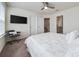 Well-lit bedroom features carpet, a ceiling fan, and an en-suite bathroom at 10414 Folly Beach Rd, Orlando, FL 32827