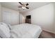 Cozy bedroom features a ceiling fan, closet space, and plush carpeting at 10414 Folly Beach Rd, Orlando, FL 32827